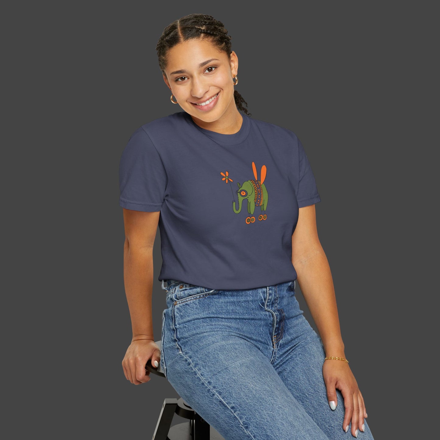 A women wearing a navy blue t-shirt with a graphic design on a gray background a t-shirt by the artist Jarrod Eastman