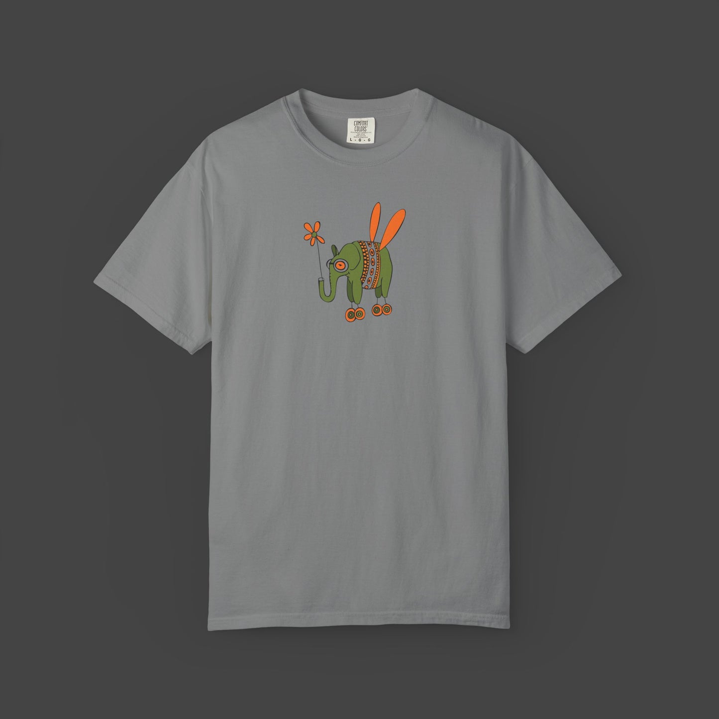The Flying Elephant Unisex T-shirt by Printify features Jarrod Eastmans playful graphic of a green elephant with orange wings, roller skates, and a flower—an irresistibly whimsical tee for fans of fun, inspiring style.