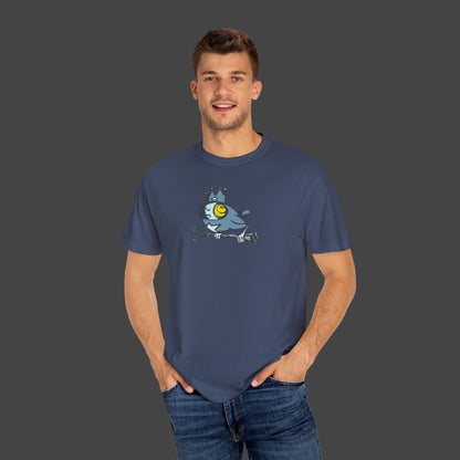 A smiling man stands against a gray background with his hands in his pockets, wearing the Biddy Surreal Bird Unisex T-shirt by Jarrod Eastman