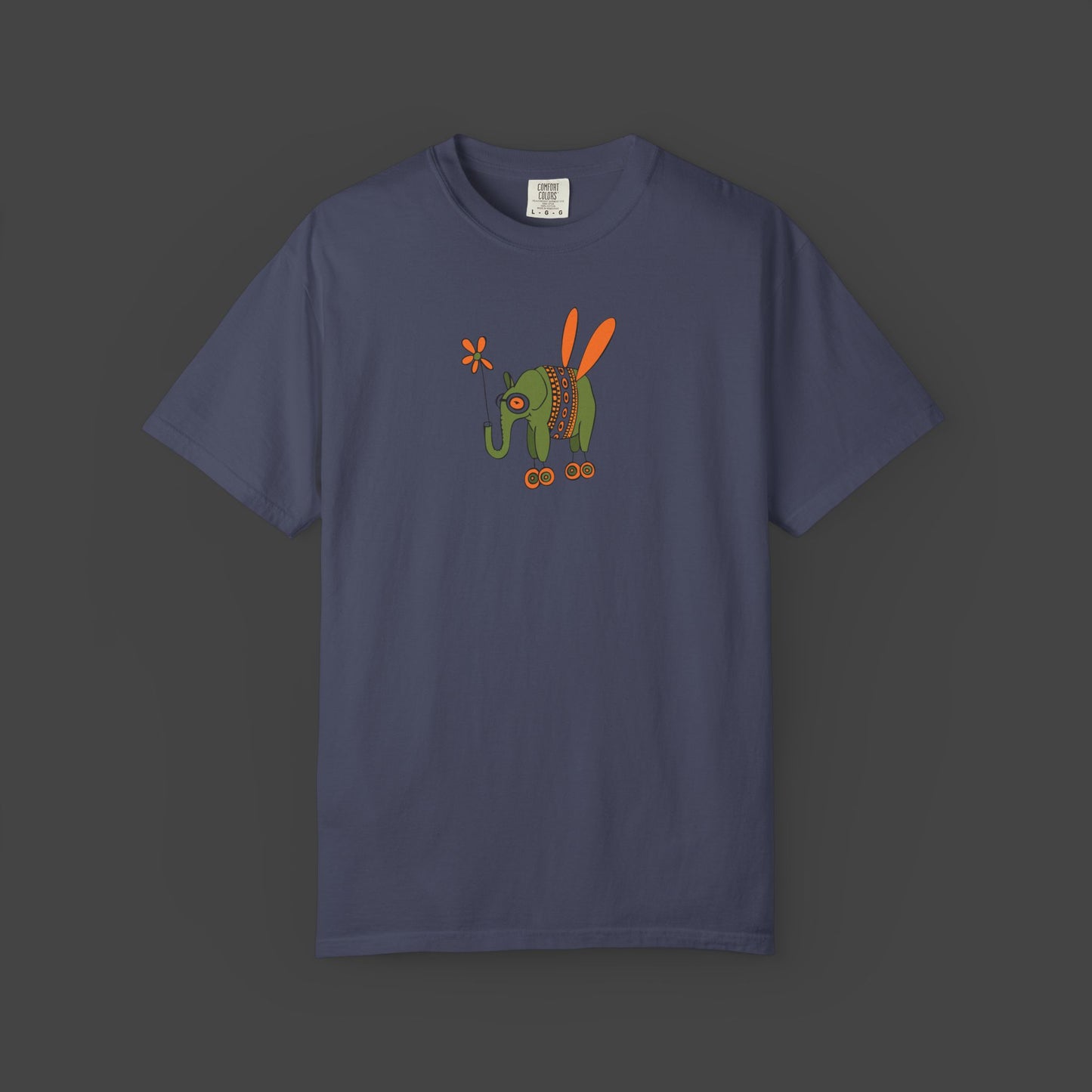 The Flying Elephant Unisex T-shirt by Printify, designed by Jarrod Eastman, features a whimsical navy blue elephant with orange wings and colorful red, orange, and green accents for an inspirational, eye-catching look.