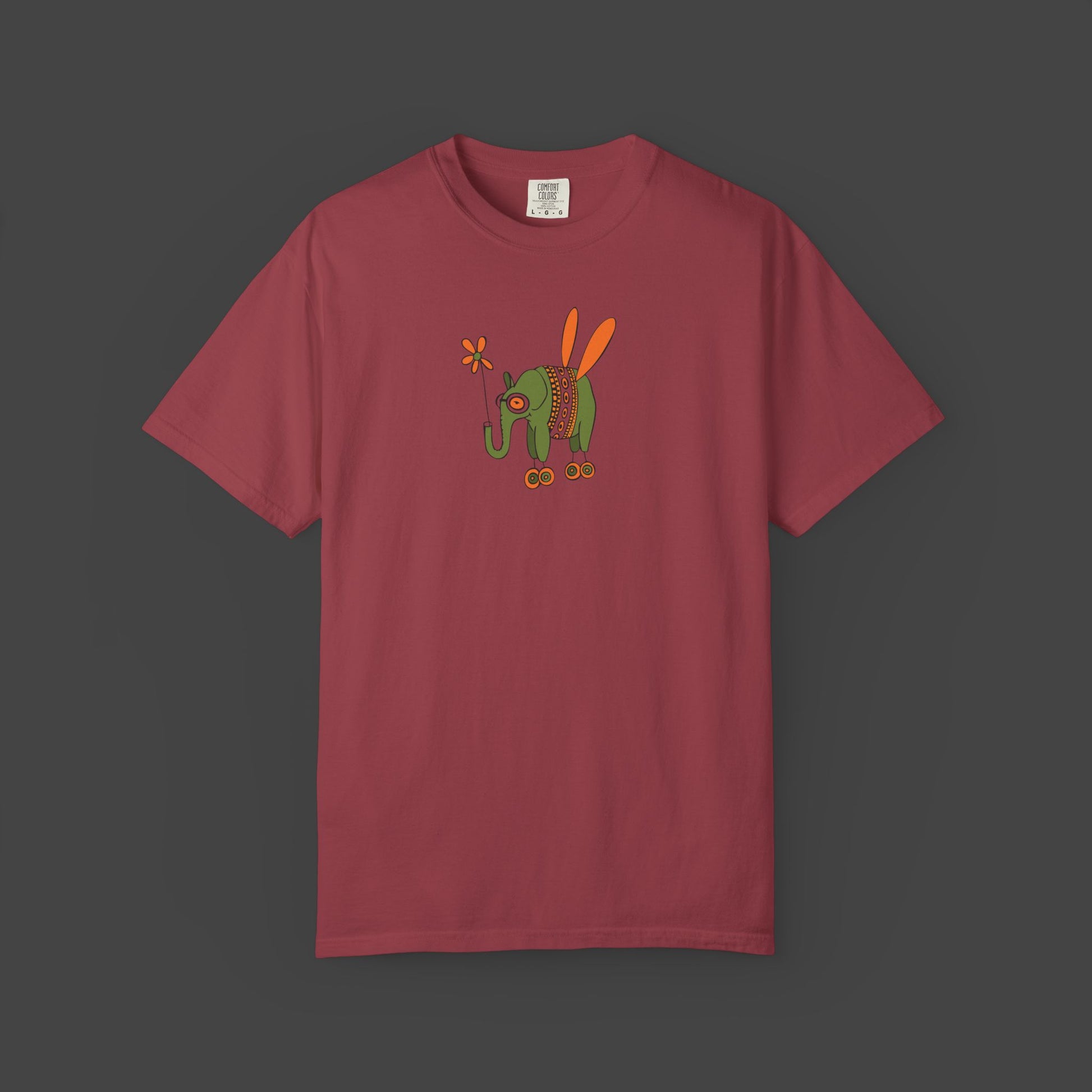 The Printify Flying Elephant Unisex T-shirt by Jarrod Eastman features an inspirational and fun maroon design with a colorful insect illustration on the chest.