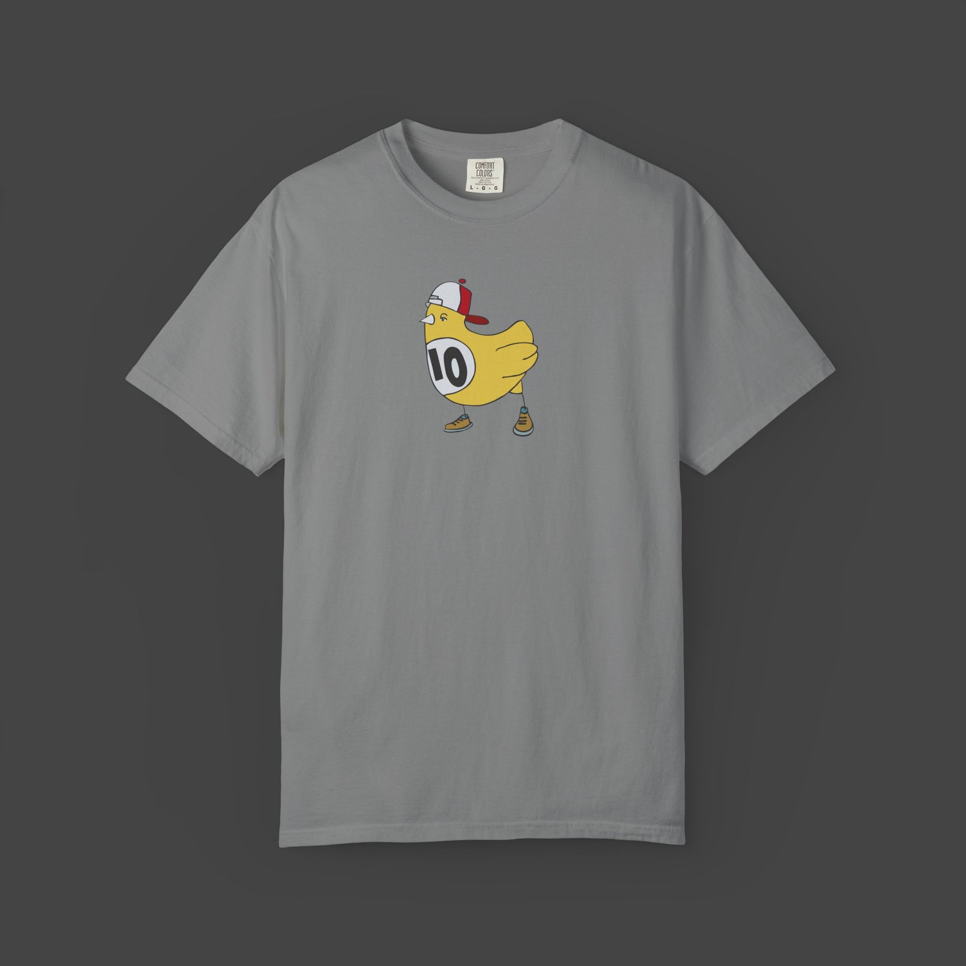 The Chicken Scratch Unisex T-shirt by Jarrod Eastman from Printify features a quirky, surreal cartoon yellow bird in a cap, brown shoes, and a #10 white jersey on a gray tee—fun art style centered on the front.