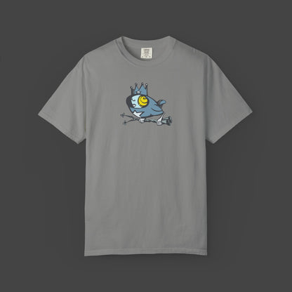 The Biddy Unisex T-shirt by Jarrod Eastman features a quirky surreal bird cartoon with a crown and bold yellow eye