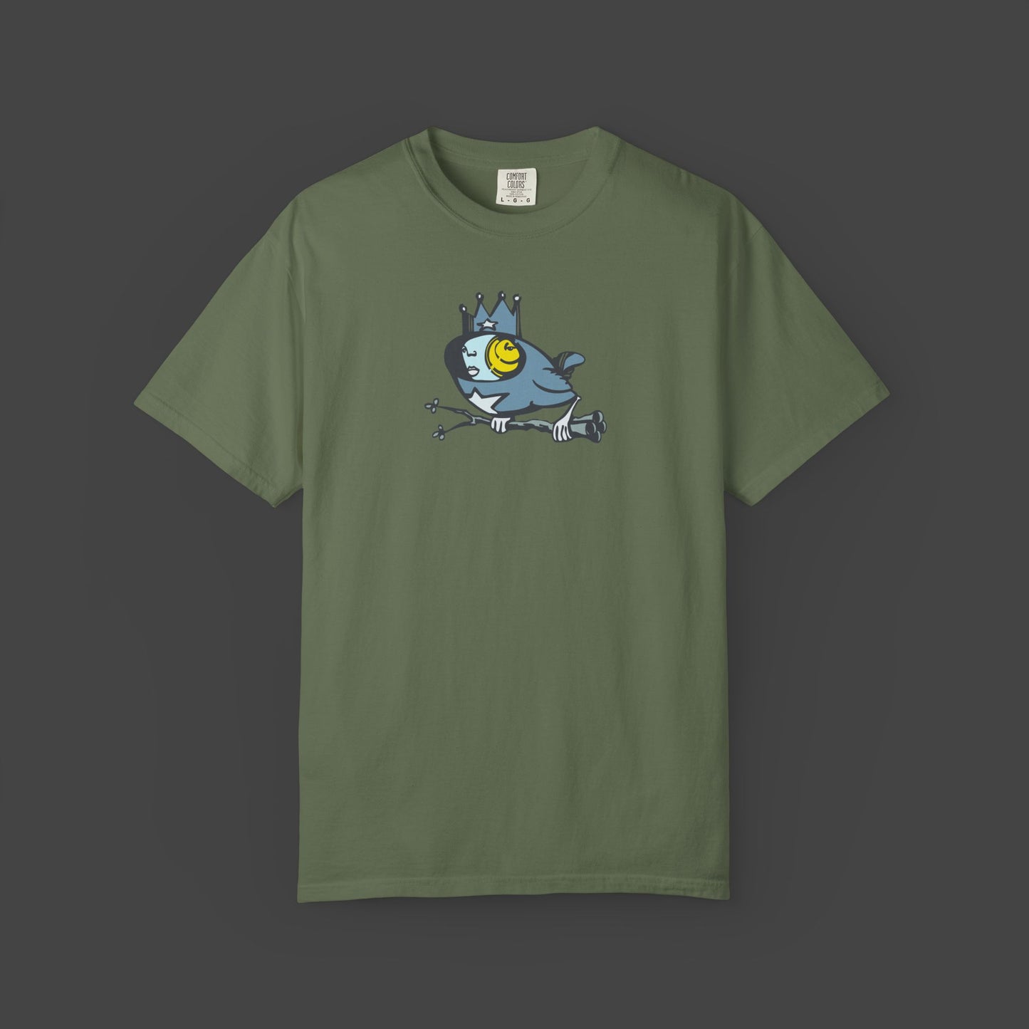 Biddy Surreal Bird Unisex T-shirt in green by Jarrod Eastman. A whimsical blue bird with a human-like face, wearing a crown and holding a branch with its claws.