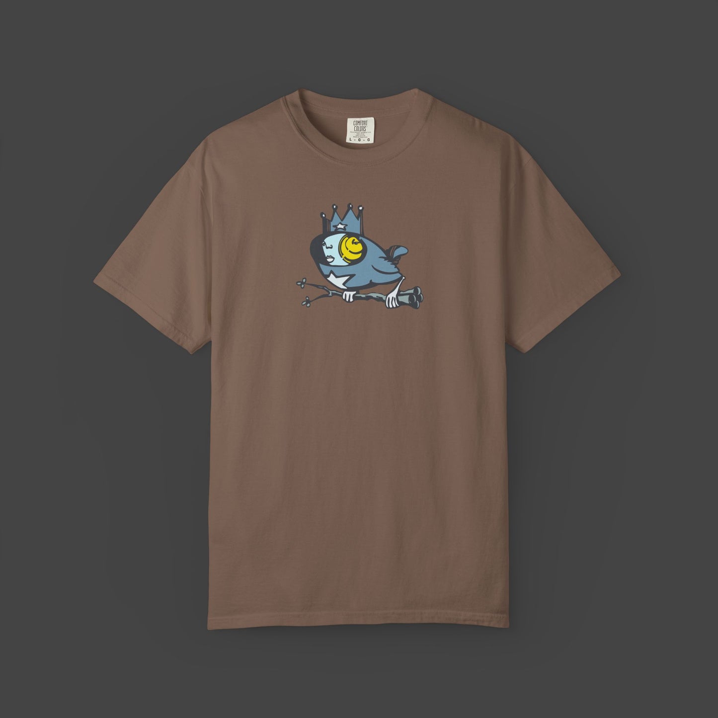 The Biddy Surreal Bird Unisex T-shirt in brown by Jarrod Eastman features a crowned blue bird with a yellow eye.