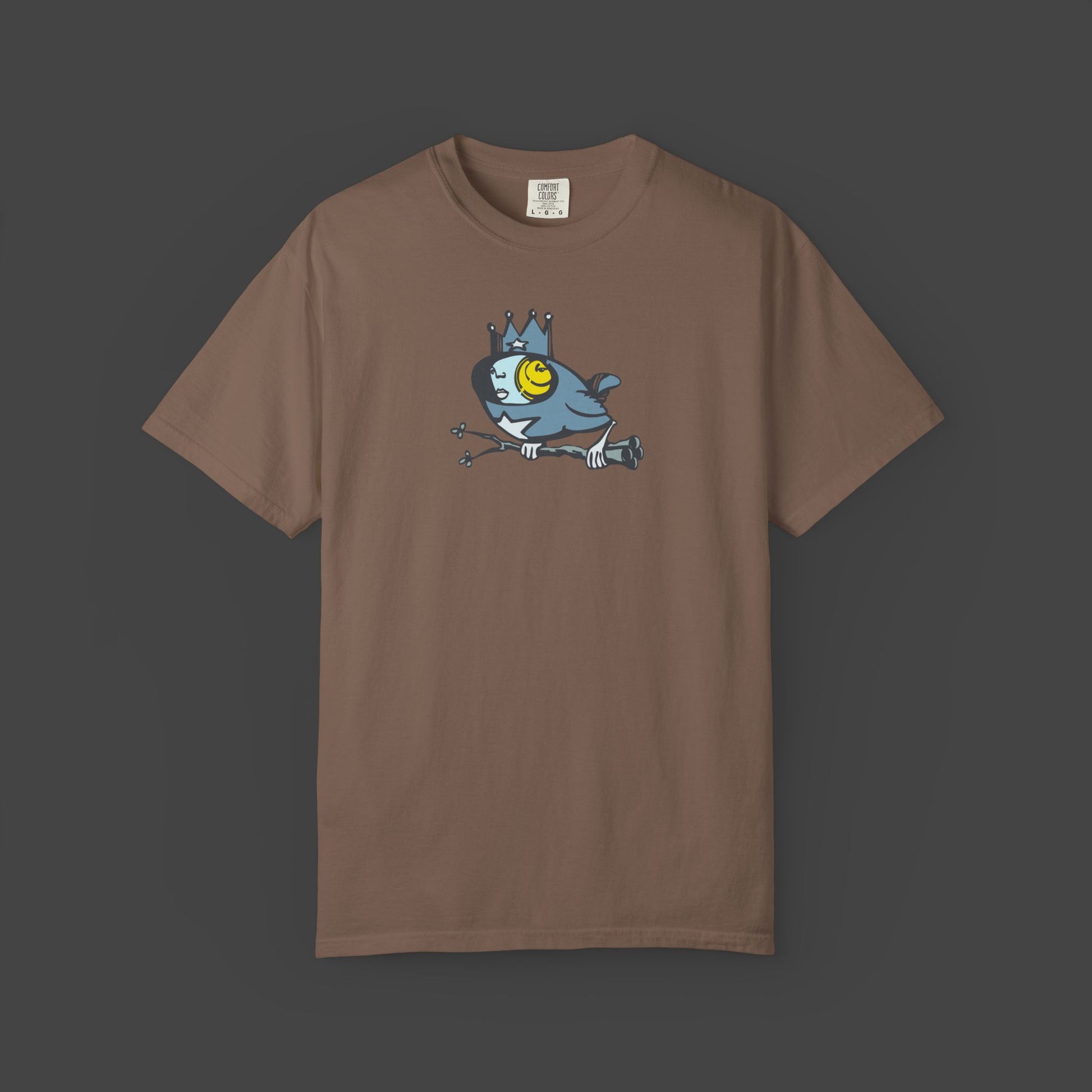 The Biddy Surreal Bird Unisex T-shirt in brown by Jarrod Eastman features a crowned blue bird with a yellow eye.