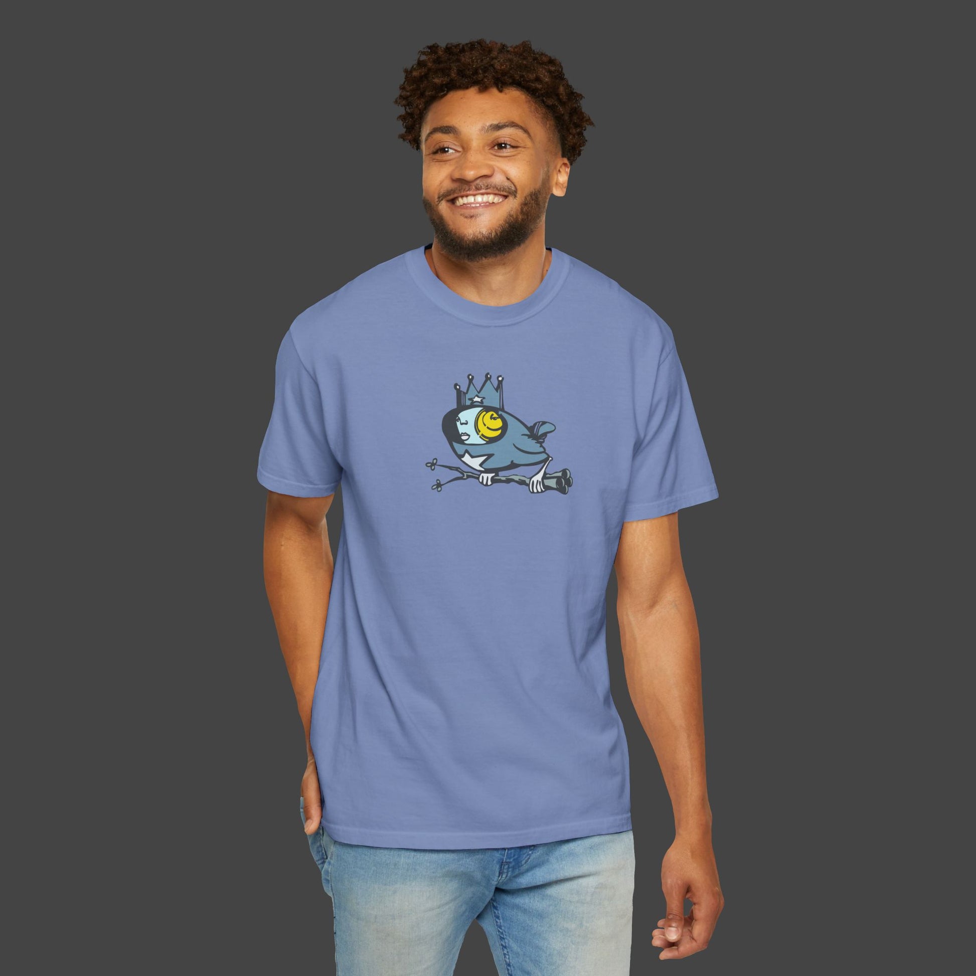 A smiling man wears the Biddy Surreal Bird Unisex T-shirt by Jarrod Eastman 